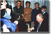 Singing Jewish songs.  German Krasilnikov is at the piano